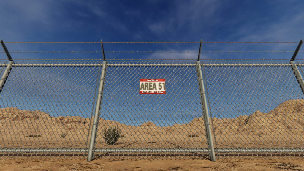 A chain link fence with a sign reading: "Warning Area 51. Restricted area."
